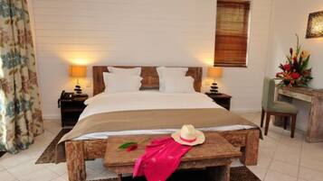 A bedroom with a bed, bedside tables, a desk, and a chair.