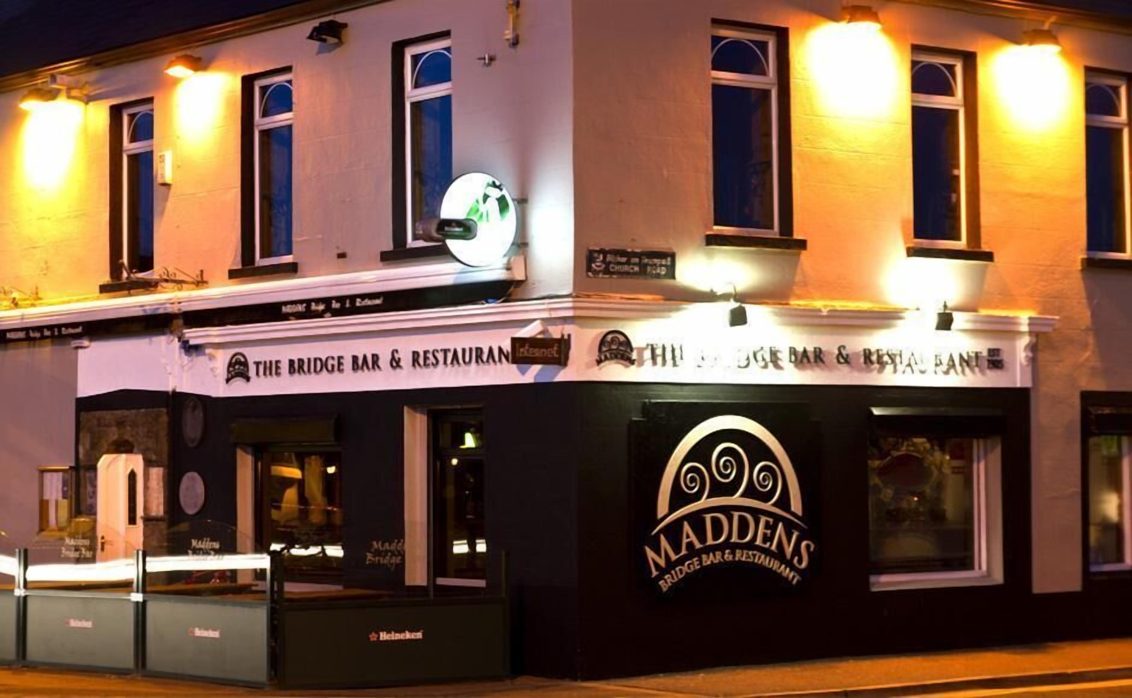 The Bridge Bar & Restaurant with a sign for Maddens Bar & Restaurant on the corner.