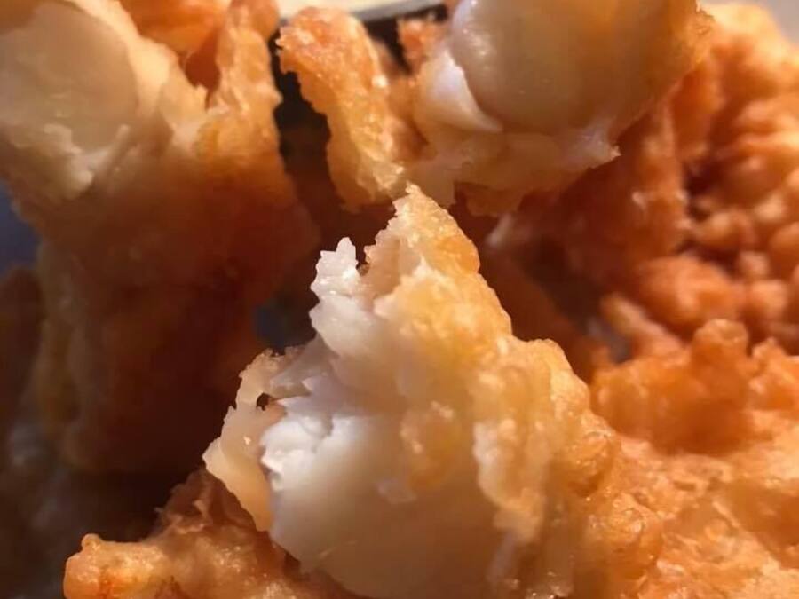 A plate of fried food with a dipping sauce.