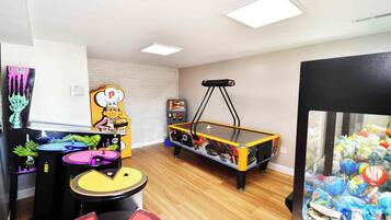 Enjoy games and entertainment in this room featuring a pool table, claw machine, and arcade games.
