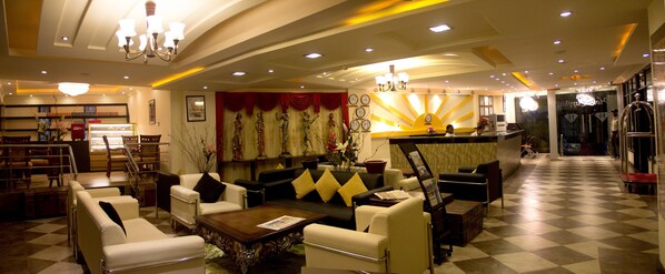 A hotel lobby with a checkered floor, a reception desk, and seating areas. - Hotel Sapphire (Dar es Salaam)