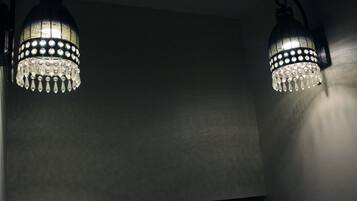 Two wall-mounted light fixtures with crystal details.
