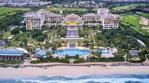 A resort with multiple buildings, a central pool, and a beachfront. - Crowne Plaza Hailing Island by IHG (Yangjiang)