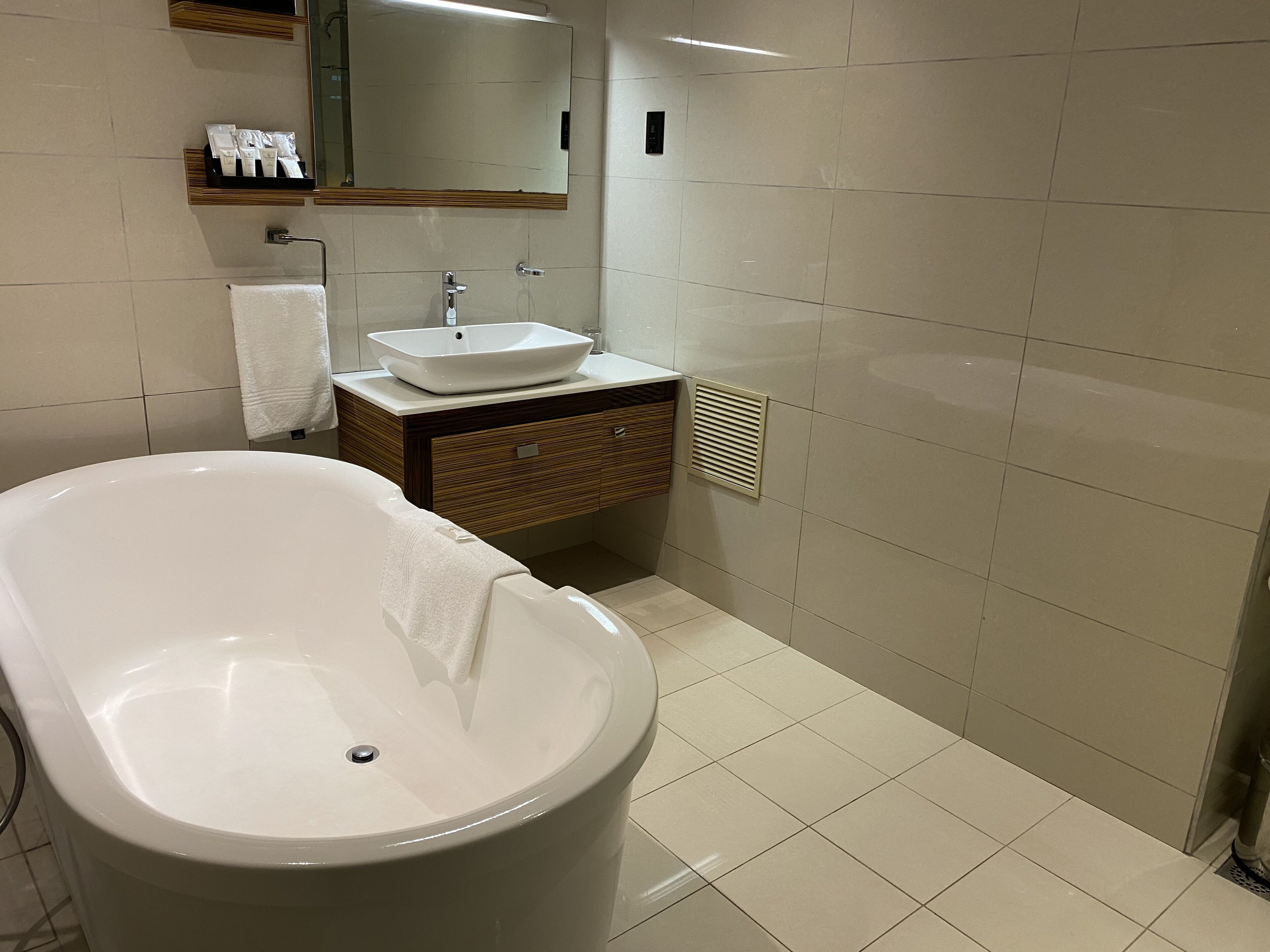 A modern bathroom with a freestanding bathtub, a sink, and a vanity.