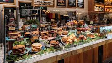 A bakery display with various baked goods and a coffee machine.