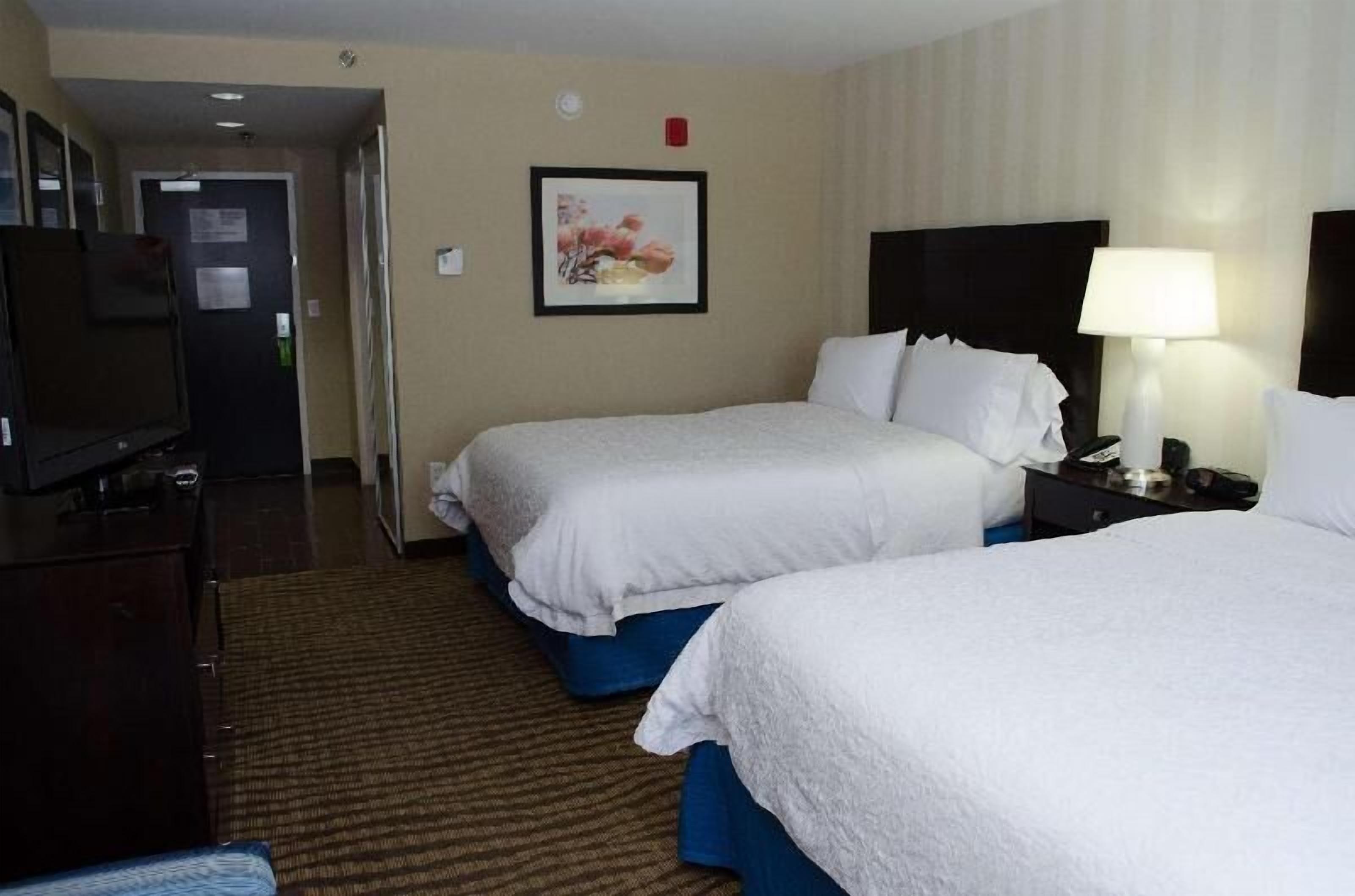 Hypo-allergenic bedding, desk, laptop workspace, blackout drapes