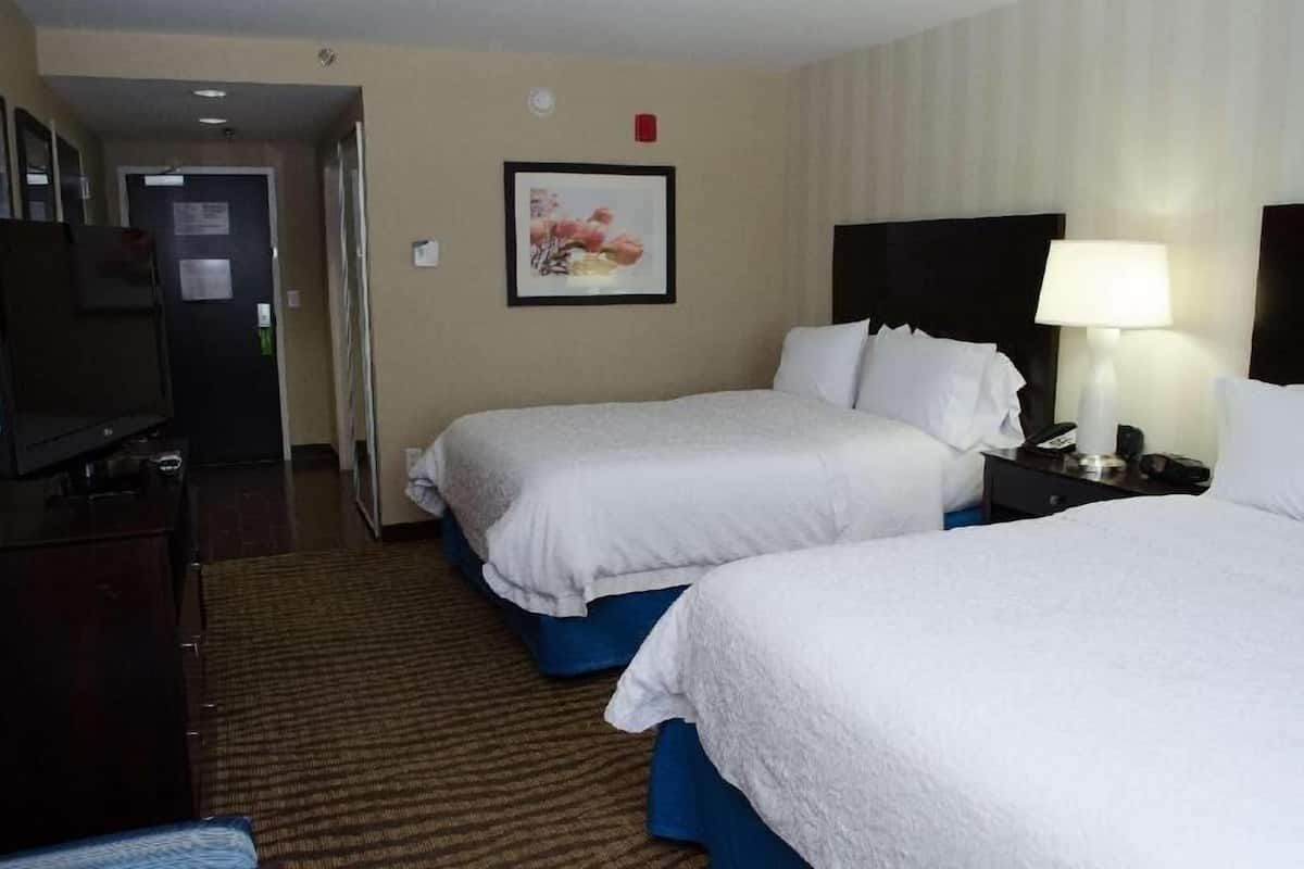 Hypo-allergenic bedding, desk, laptop workspace, blackout drapes