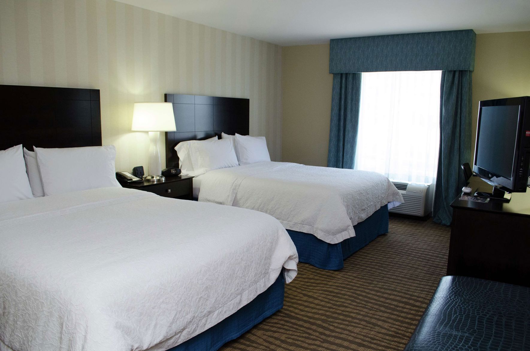 Hypo-allergenic bedding, desk, laptop workspace, blackout drapes