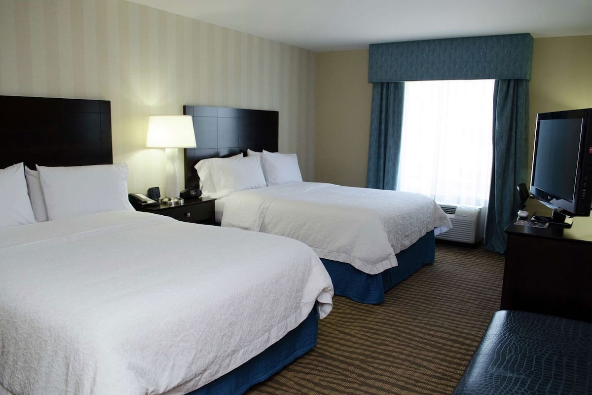 Hypo-allergenic bedding, desk, laptop workspace, blackout drapes