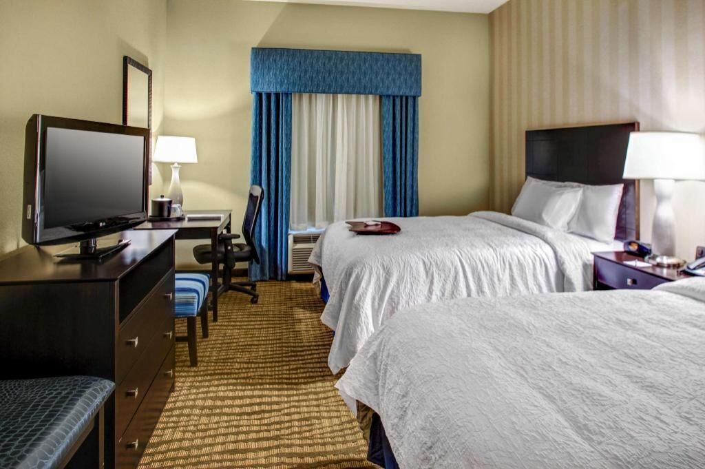 Hypo-allergenic bedding, desk, laptop workspace, blackout drapes