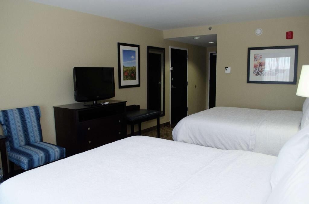 Hypo-allergenic bedding, desk, laptop workspace, blackout drapes