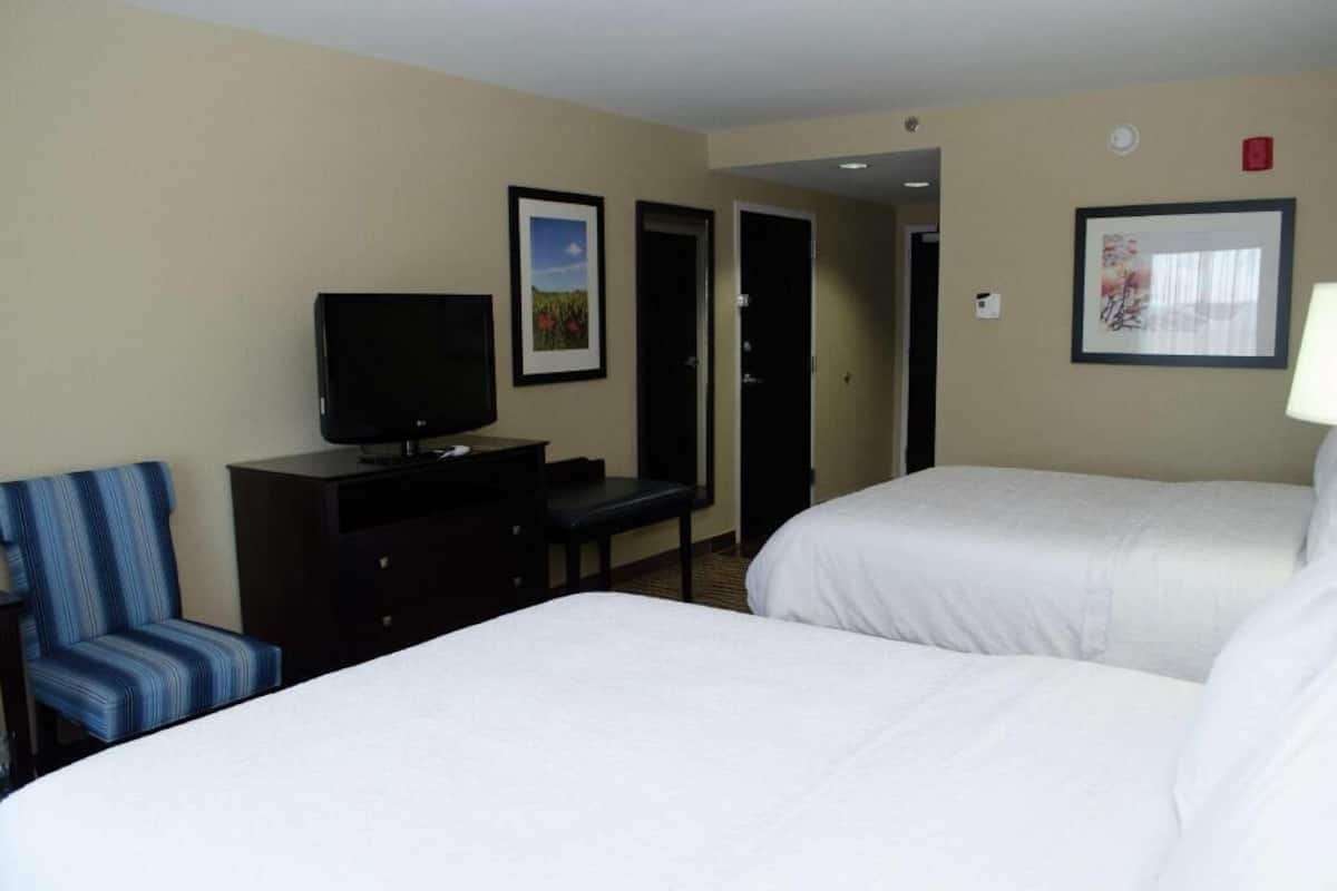 Hypo-allergenic bedding, desk, laptop workspace, blackout drapes