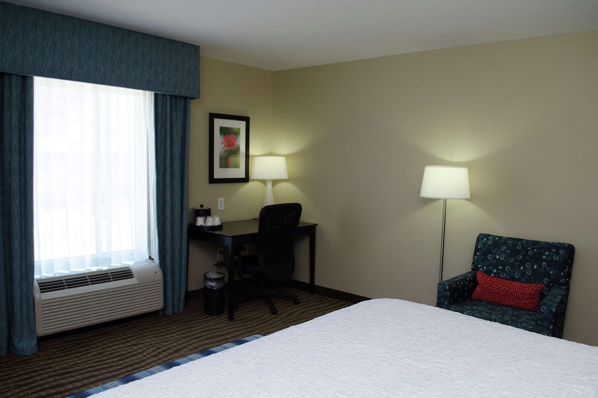 Hypo-allergenic bedding, desk, laptop workspace, blackout curtains