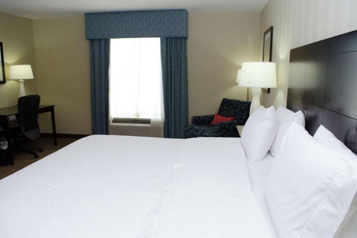Hypo-allergenic bedding, desk, laptop workspace, blackout drapes