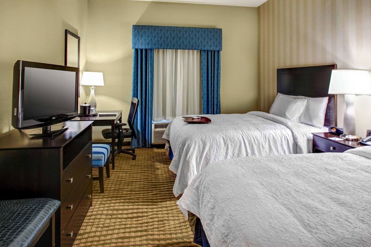 Hypo-allergenic bedding, desk, laptop workspace, blackout drapes