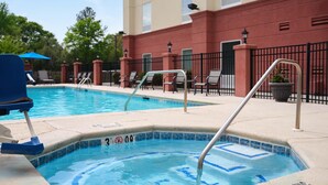 A swimming pool with a blue chair and a metal ladder.