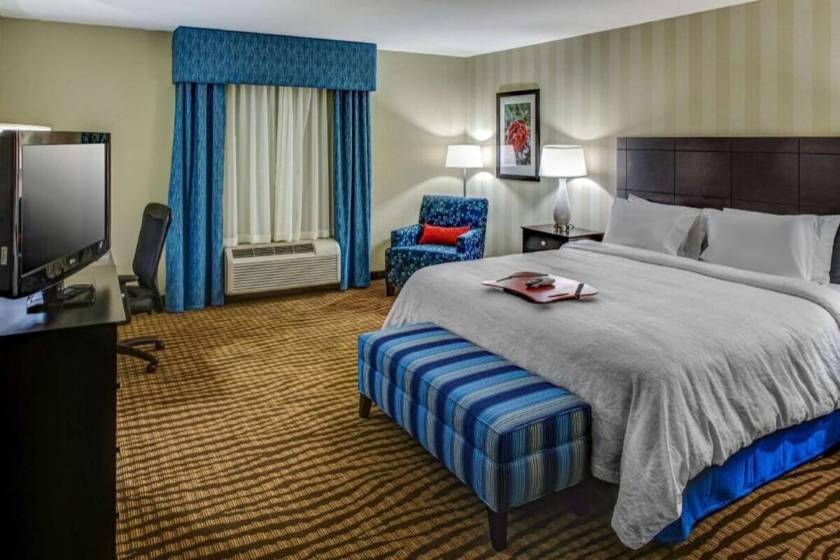 Hypo-allergenic bedding, desk, laptop workspace, blackout drapes