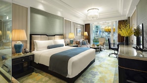A hotel room with a large bed, a desk, a chair, a TV, and a view of a building outside. - InterContinental Chengdu Global Center by IHG (Chengdu)