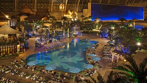 A resort with a large pool, outdoor dining areas, and a starry night sky projection. - InterContinental Chengdu Global Center by IHG (Chengdu)