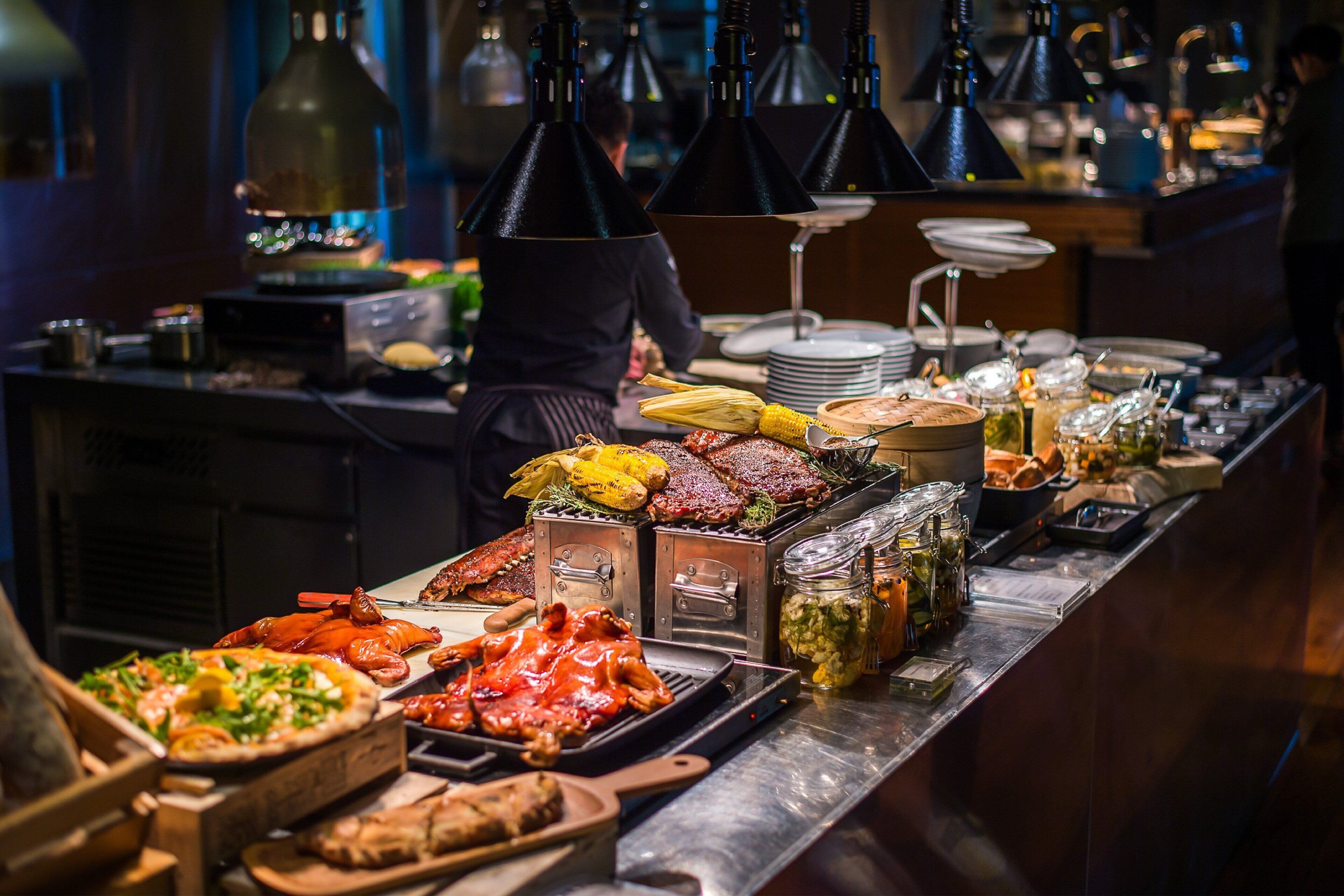 A buffet with various dishes including seafood, meats, and vegetables.