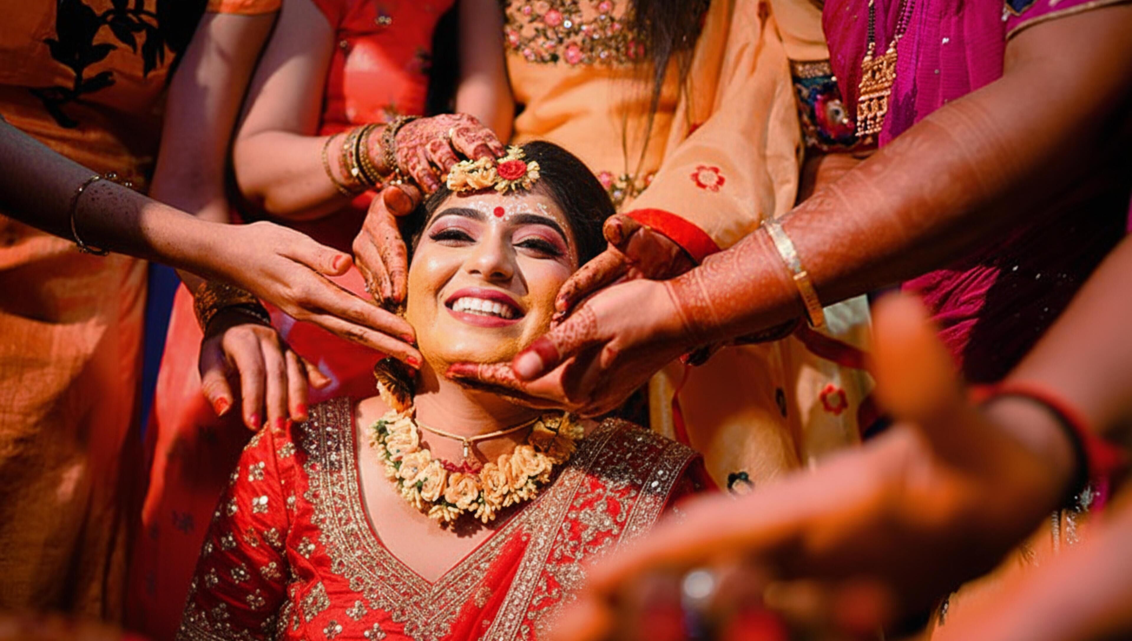 A person in traditional attire surrounded by others, suggesting a cultural or ceremonial event.