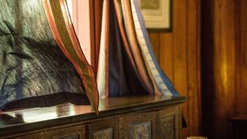 A wooden cabinet with intricate carvings and a glass display case.