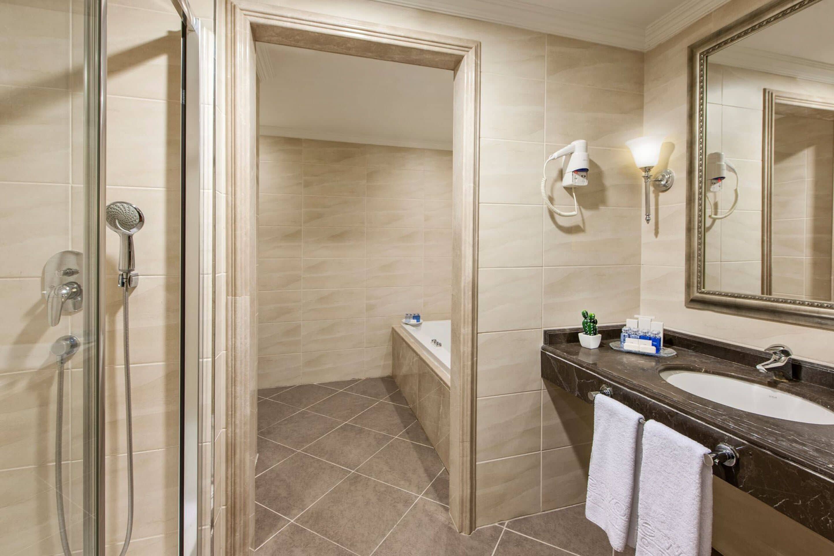 suite with king size bed | bathroom | separate bathtub and shower, hydromassage showerhead, free toiletries