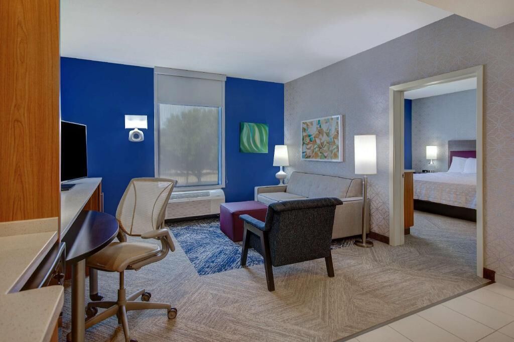 Hypo-allergenic bedding, desk, laptop workspace, blackout drapes