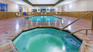 A large indoor swimming pool with a tiled deck and a metal ladder. - La Quinta Inn & Suites by Wyndham Floresville (Floresville)