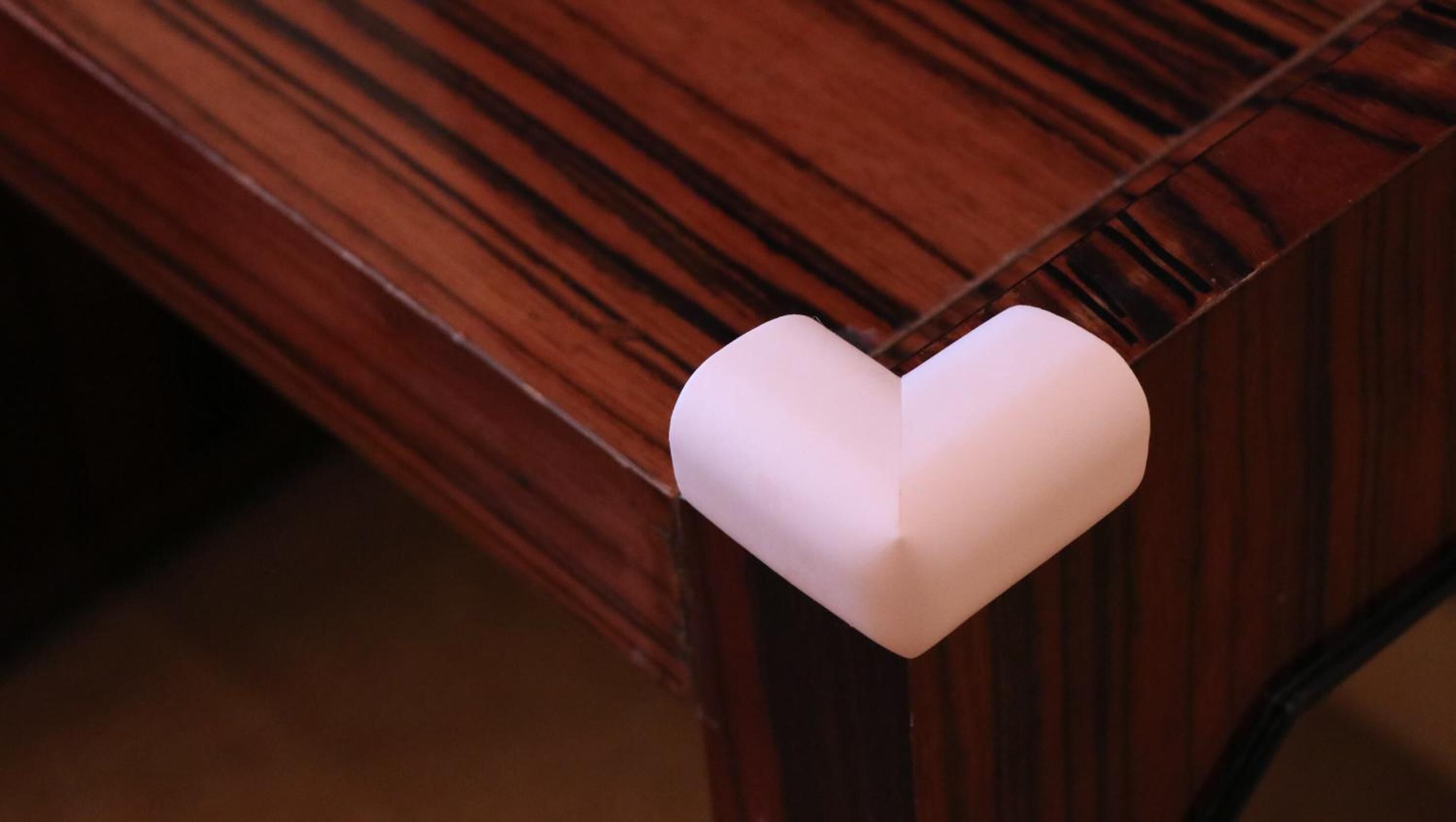 A wooden table with a white heart-shaped object on it.