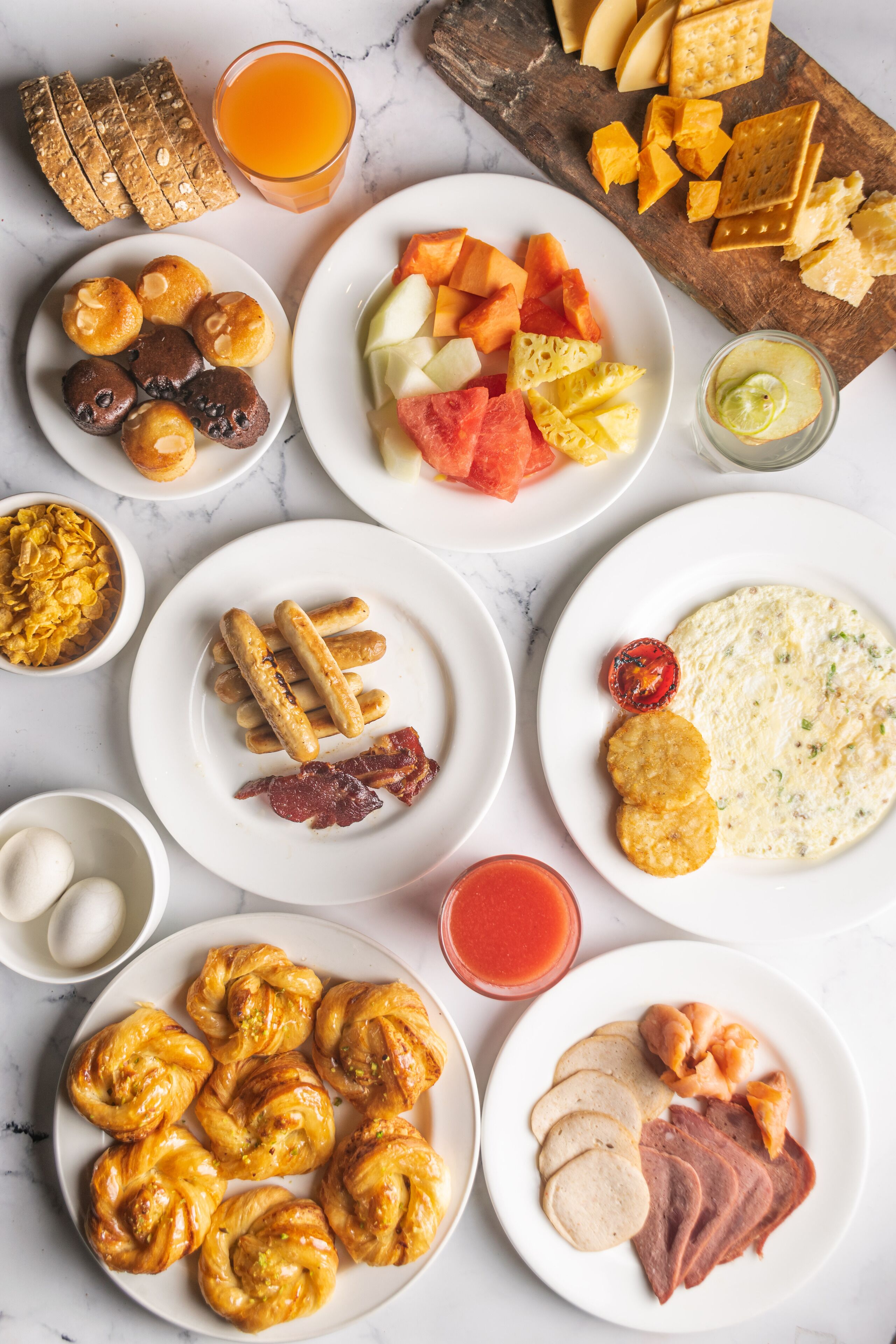 A breakfast spread with various foods and drinks.