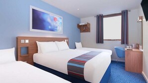 A hotel room with two beds, a desk, a chair, a window with curtains, and a painting on the wall. - Travelodgellanelli Cross Hands (Llanelli)