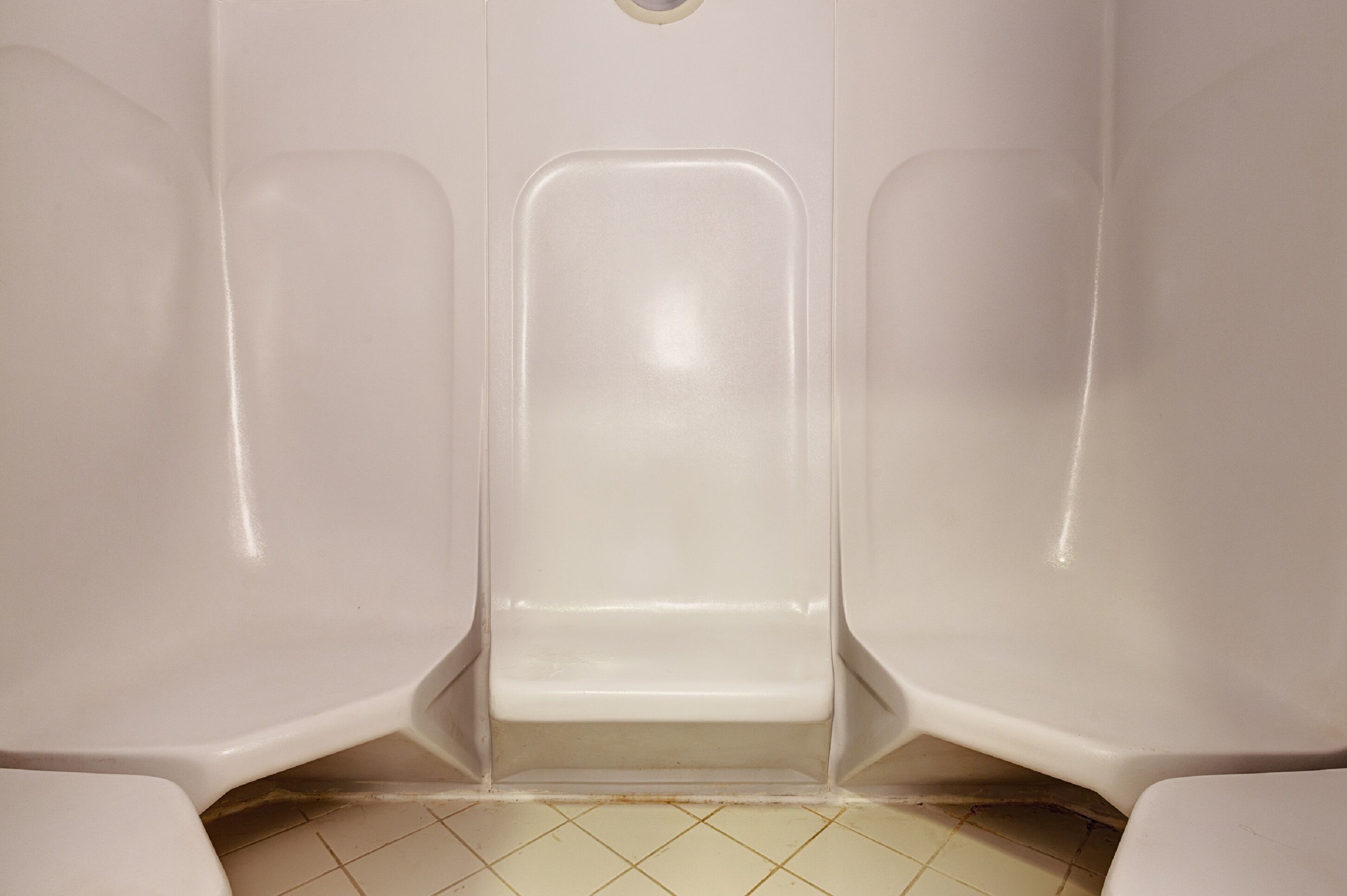 A public restroom with a single toilet stall, a sink, and a mirror.