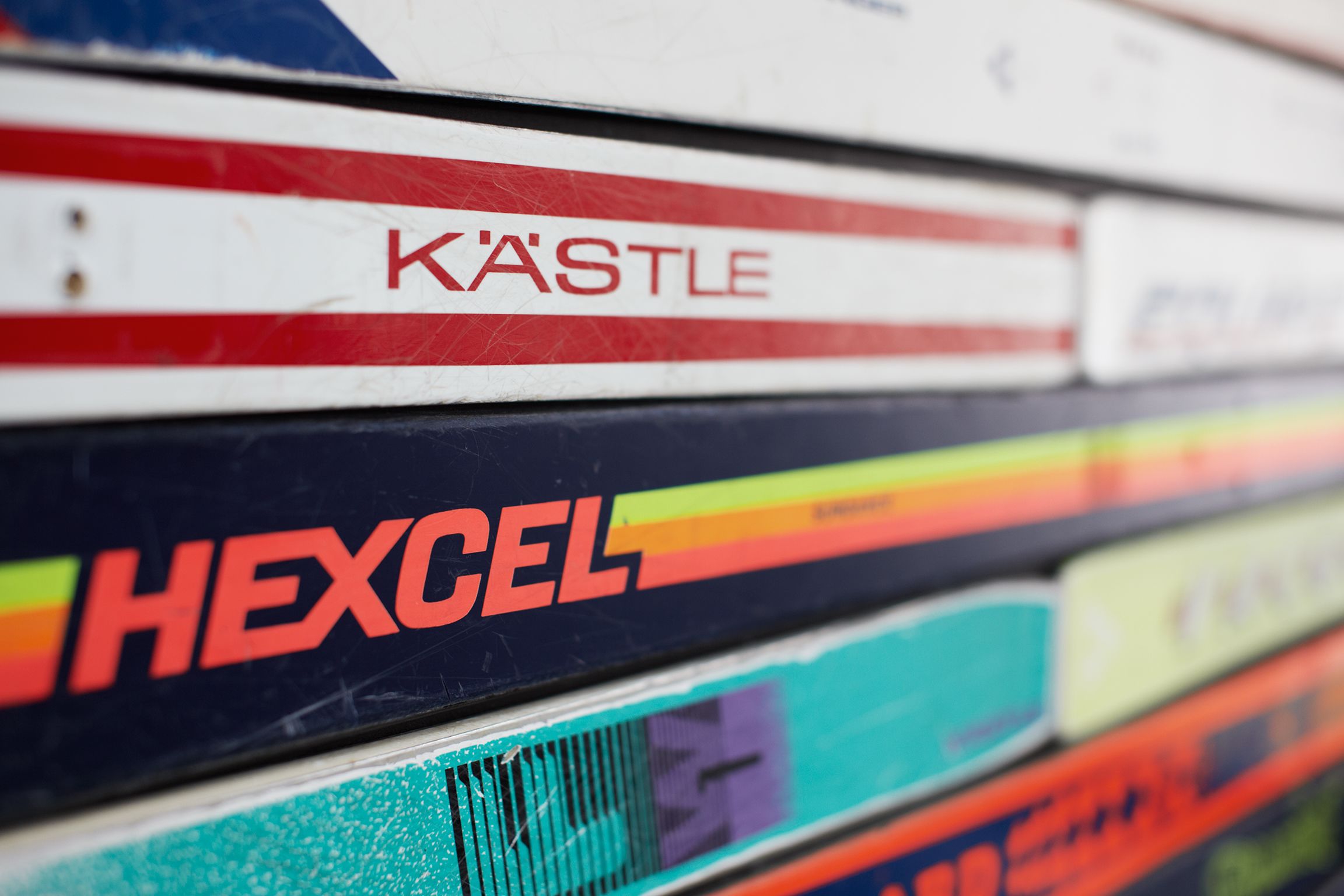 A stack of colorful book spines with visible titles like "K'ASTLE" and "HEXCEL".