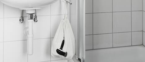 A bathroom with a white sink, mirror, and towel rack.