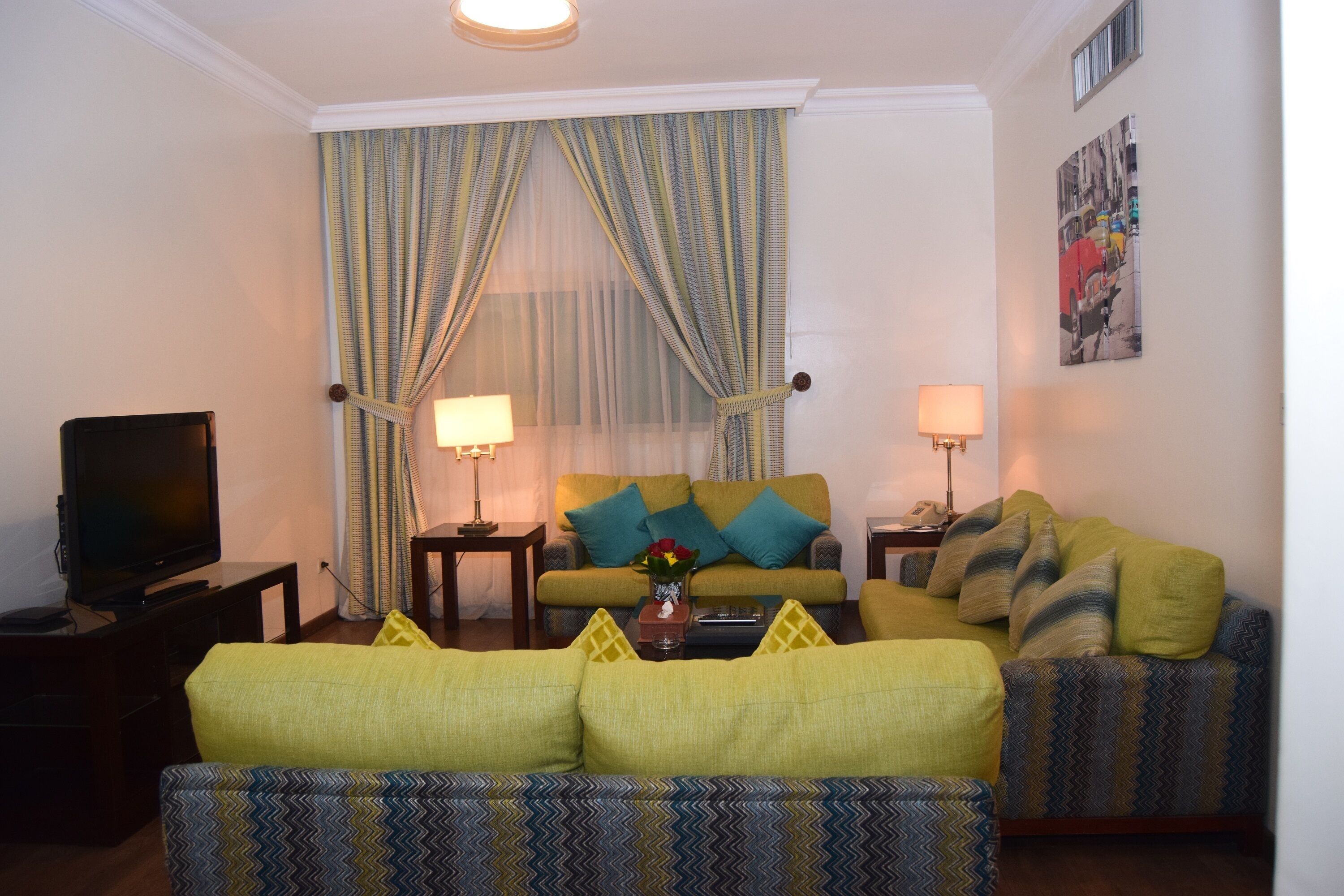 A living room with a sofa, a television, and a coffee table.