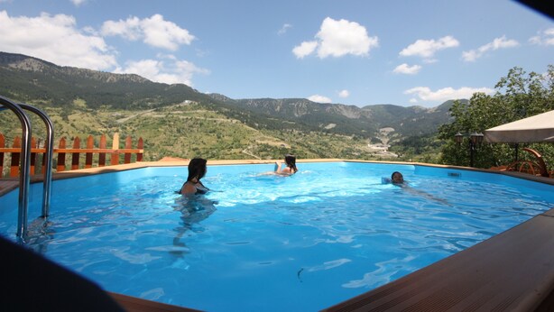 A swimming pool with a view of mountains. - Archontiko Metsovou Boutique Hotel (Metsovo)