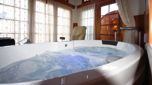 A hot tub in a room with large windows and wooden trim. - Archontiko Metsovou Boutique Hotel (Metsovo)