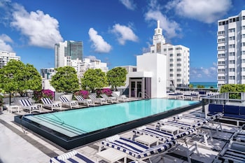 Outdoor pool, sun loungers at Gale South Beach, Curio Collection by Hilton