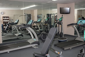 A gym with treadmills, elliptical machines, and weight equipment. - Candlewood Suites Logan by IHG (Logan)