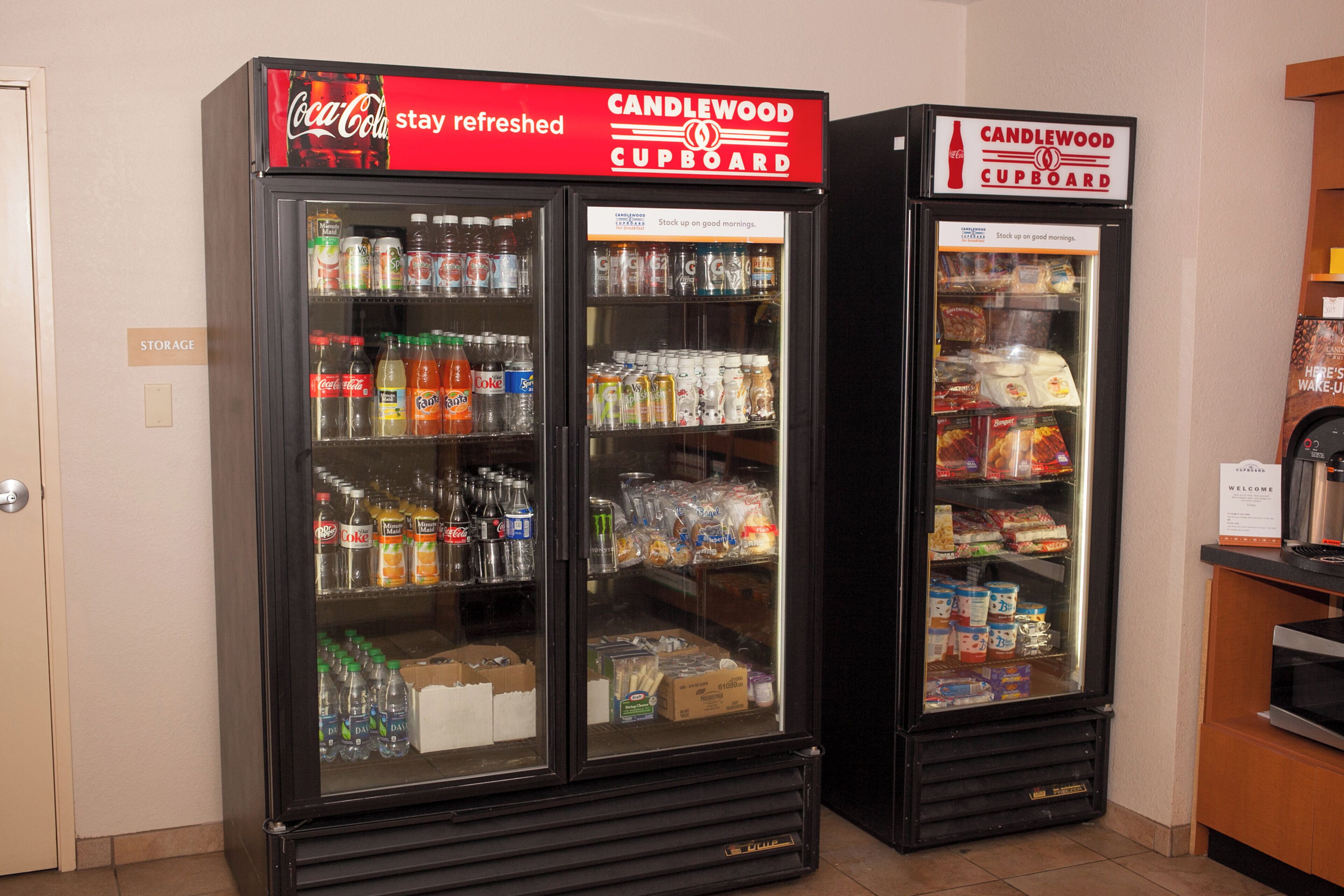 Two beverage vending machines with a variety of drinks and snacks.