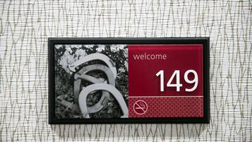 A welcome sign with the number 149, a no-smoking symbol, and a photo of a horse.