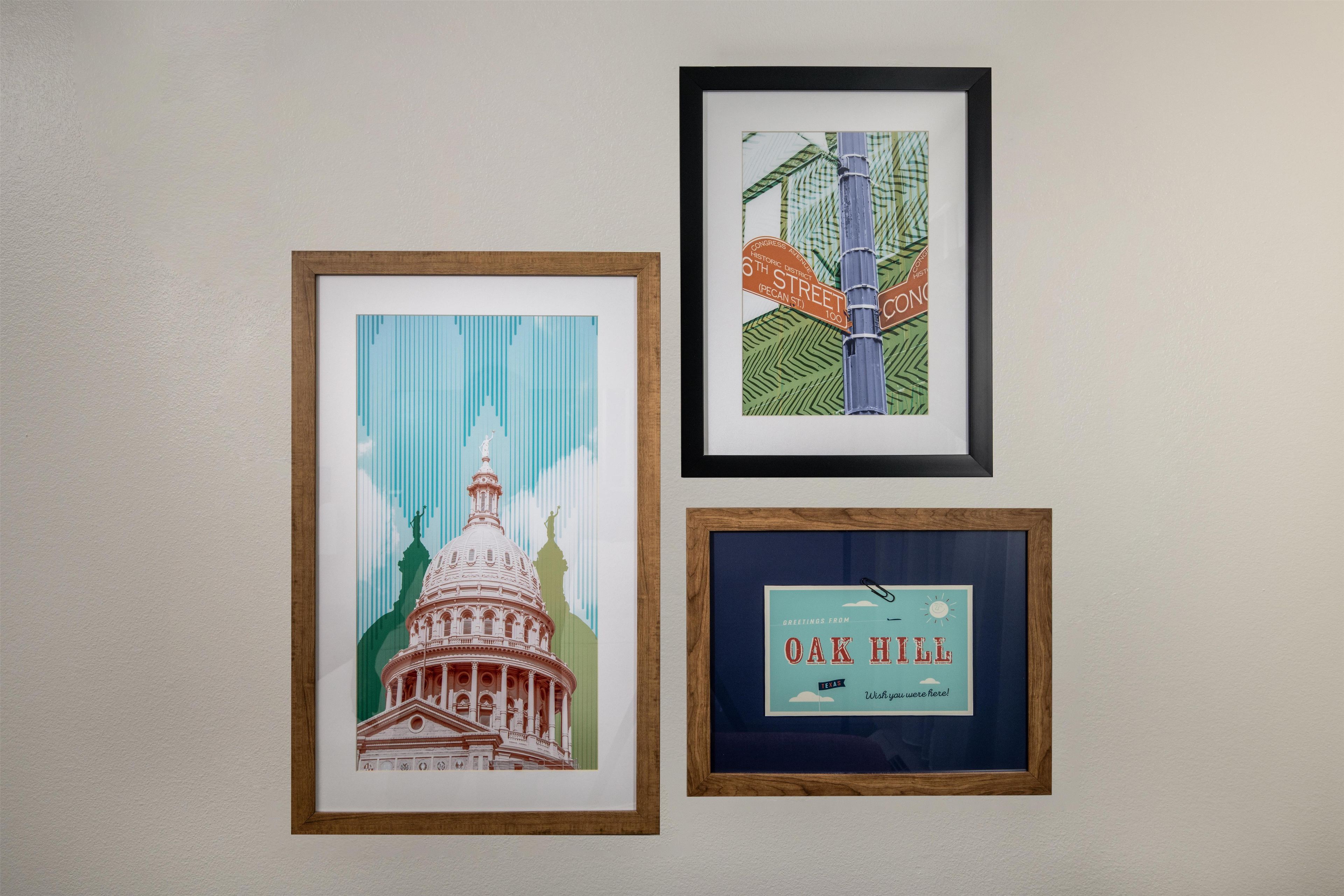 Three framed artworks on a wall.