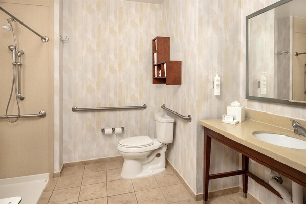 A bathroom with a shower, toilet, and sink.