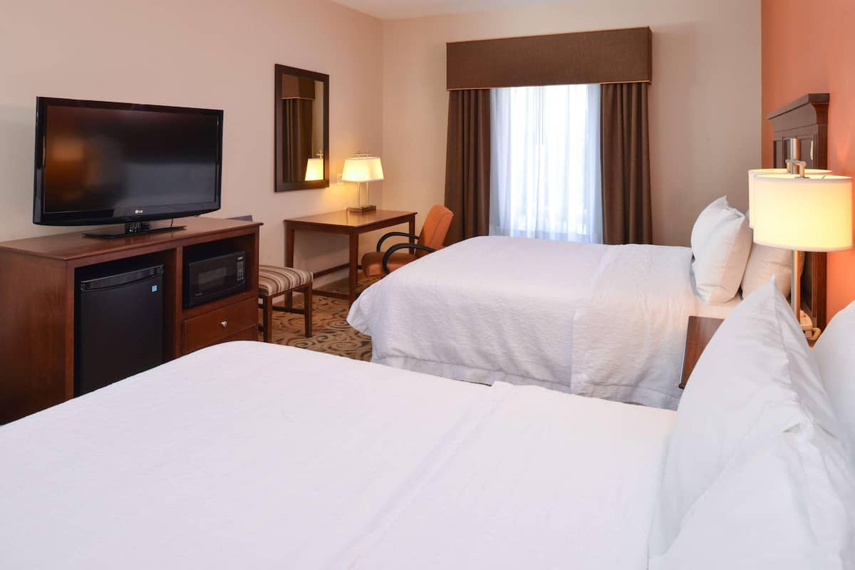 Premium bedding, desk, laptop workspace, blackout drapes