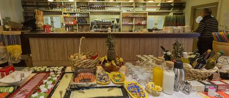 A buffet setup with various food items and beverages.