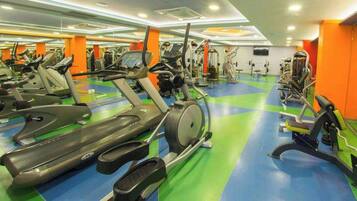 A gym with multiple treadmills, stationary bikes, and weight machines.
