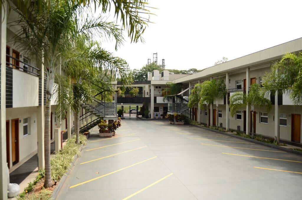 A courtyard with a central staircase, surrounded by buildings with balconies and windows.