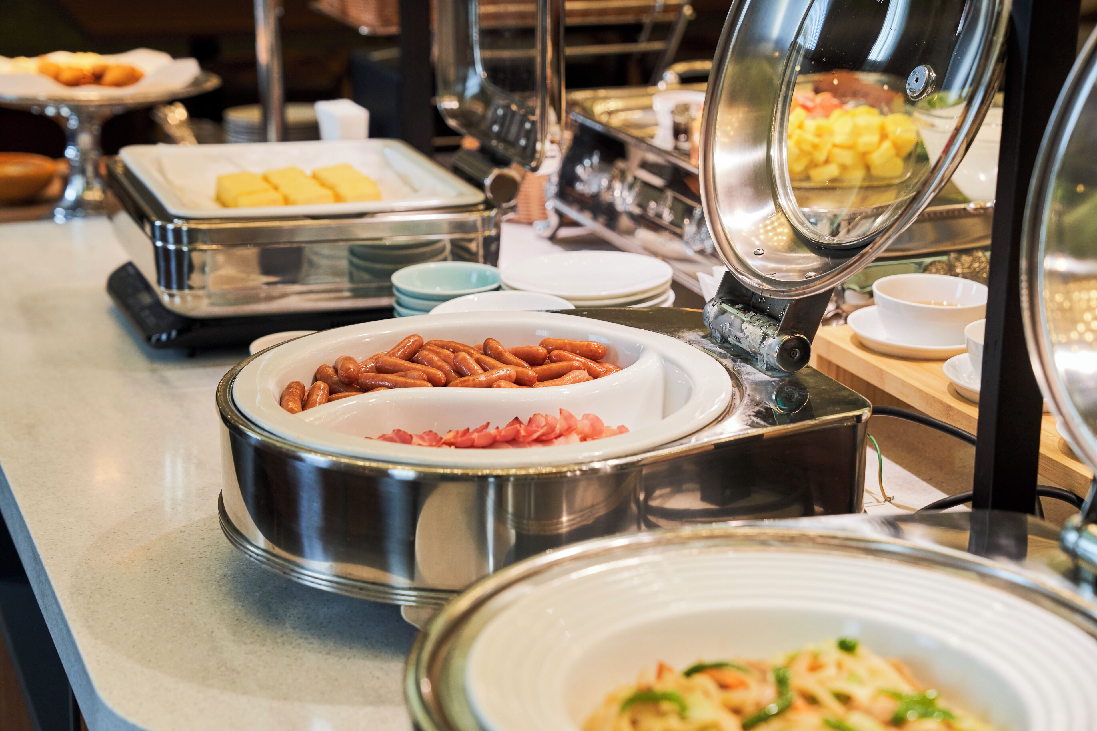 A buffet with various food items and serving dishes.
