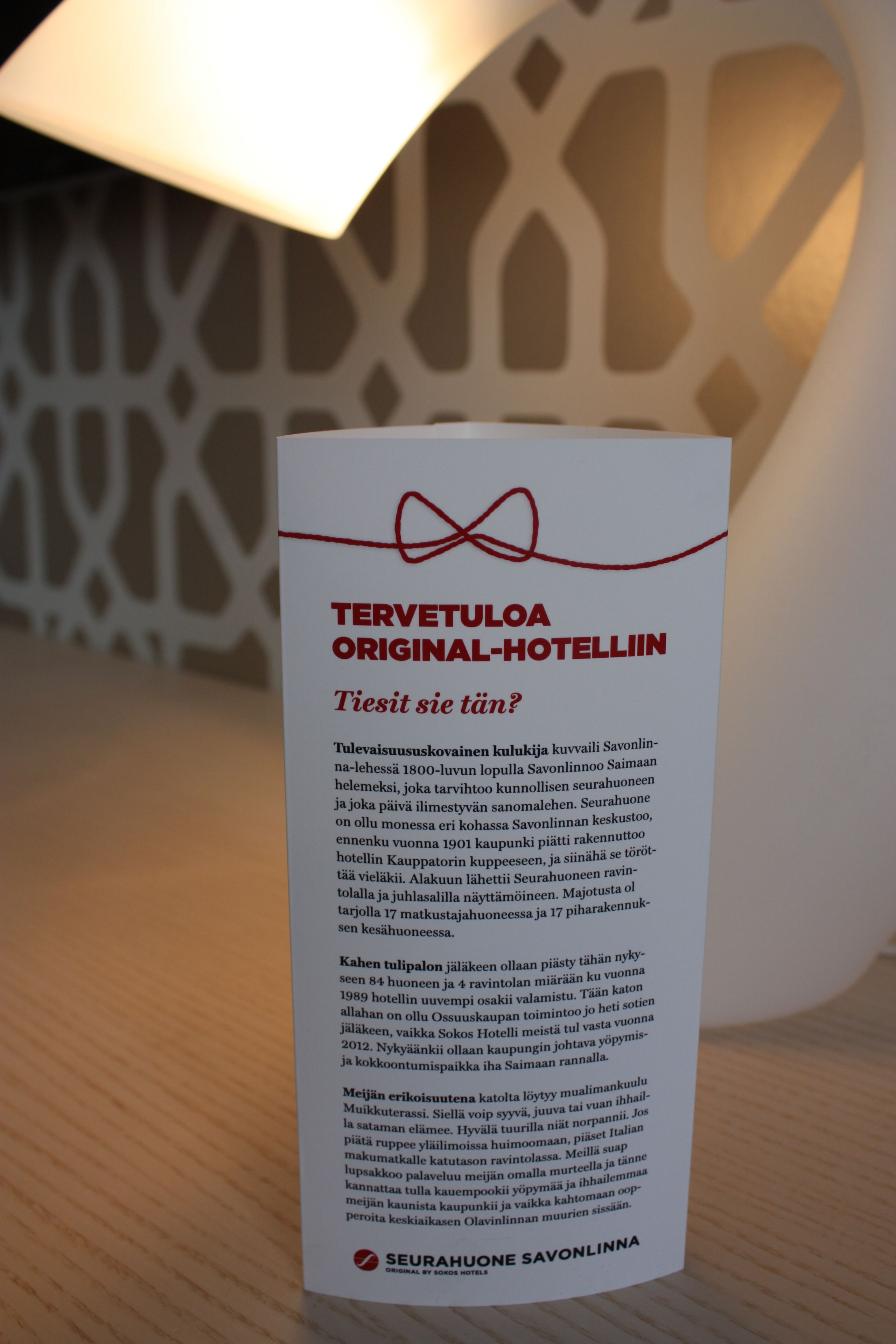 A signboard for Seurahuone Savonlinna hotel detailing its history and amenities.